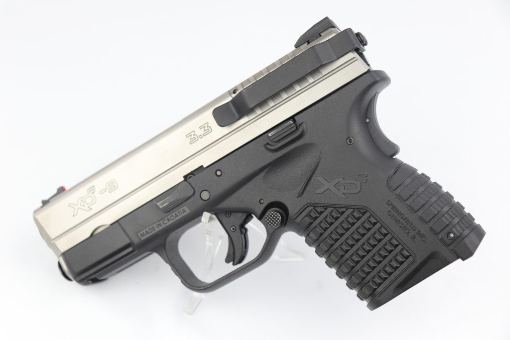 A Clipdraw concealed carry clip installed on an automatic pistol.