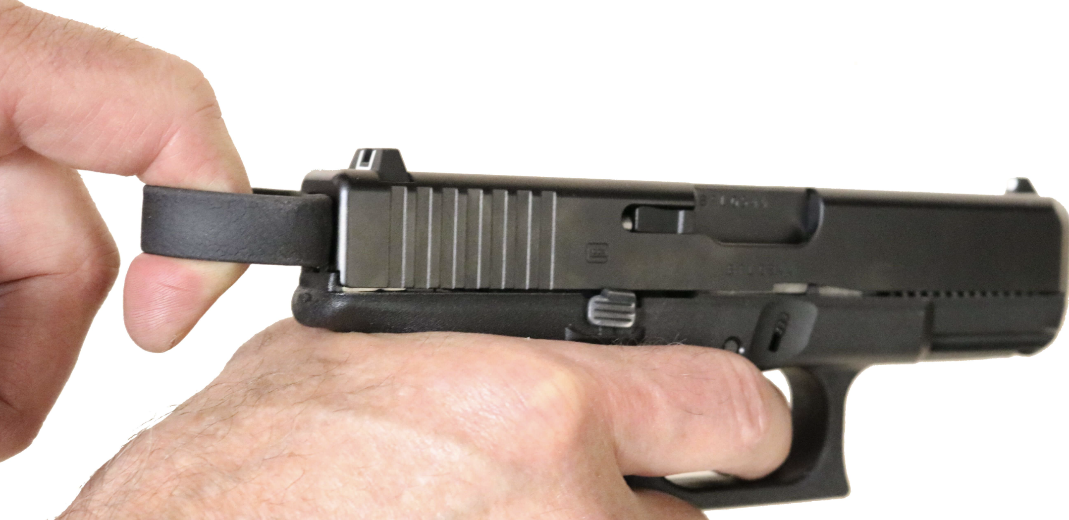 A close-up of a gun owner racking a slide with a Clipdraw charging handle.